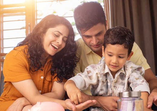 Family putting coins in piggy bank