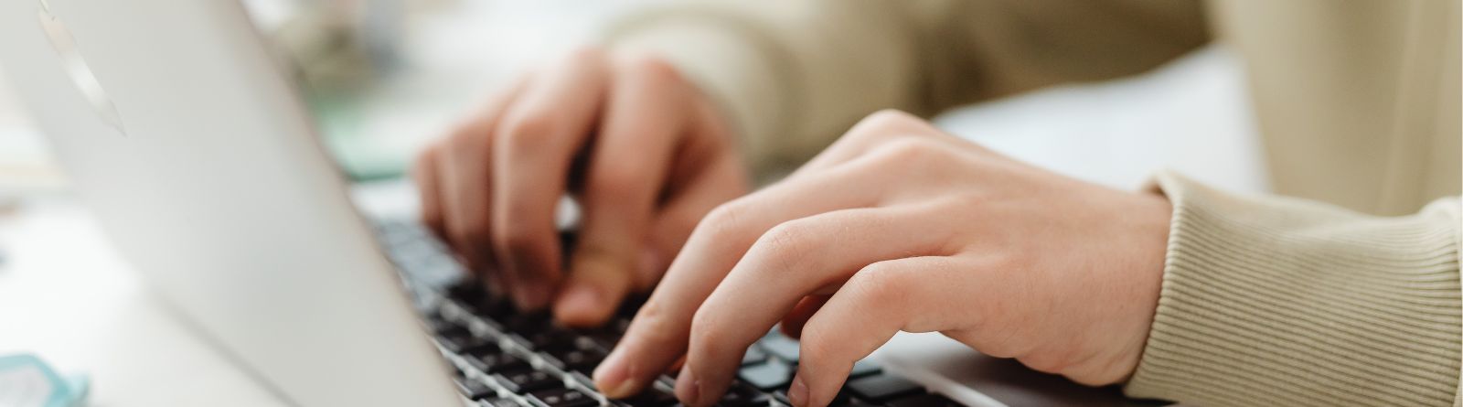 A close-up of someone typing on a computer