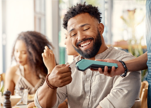 Man paying with credit card at restaurant