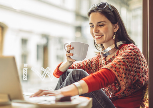 Woman using laptop in coffee shop