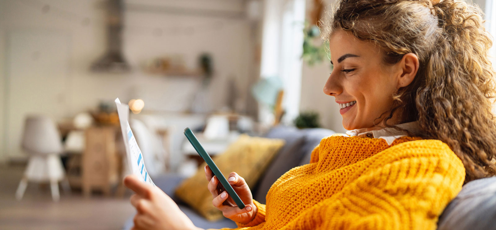 Woman using phone in living room